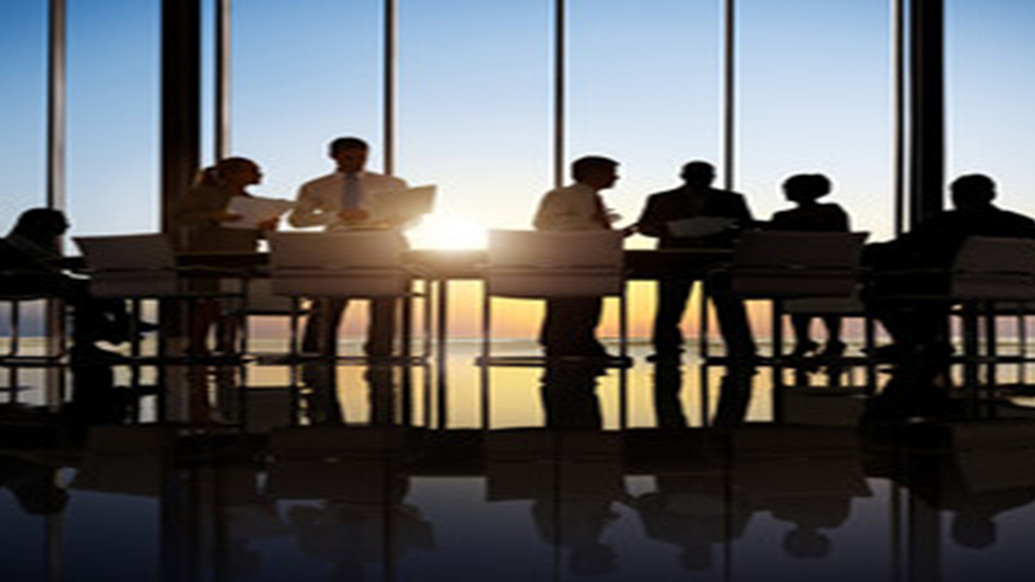 people in a meeting room at sunset